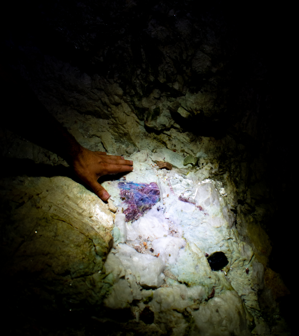 Paraíba tourmaline visible in its rock matrix