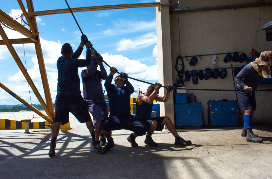 Workers Raise Gem-Ore in Unison